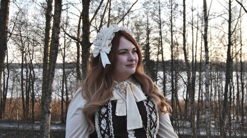 Nainen keväisessä koivumetsässä.